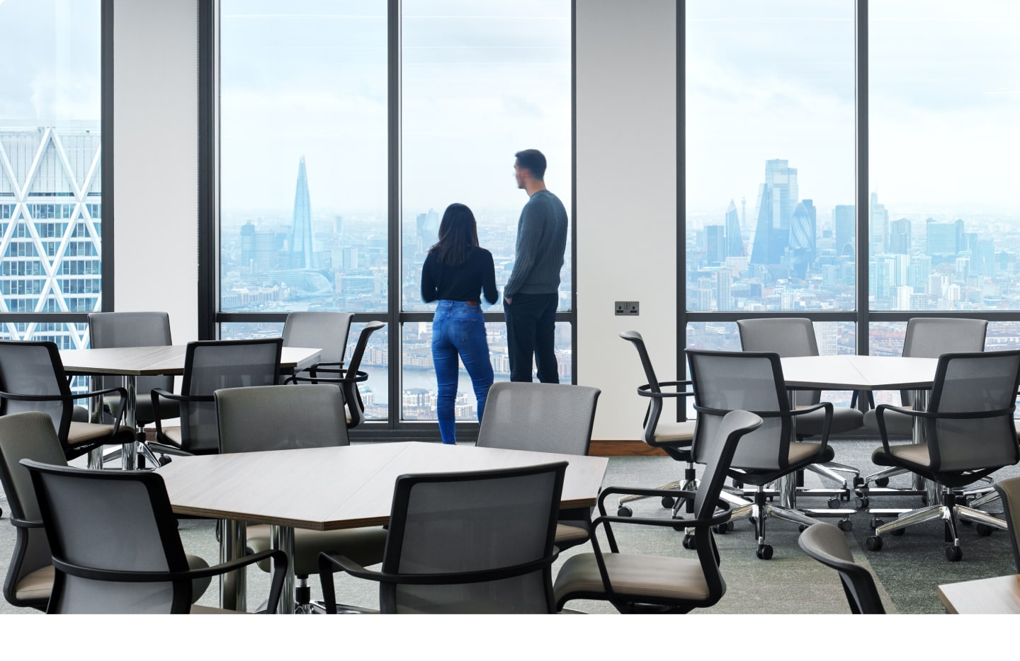 People looking outside from a tall building