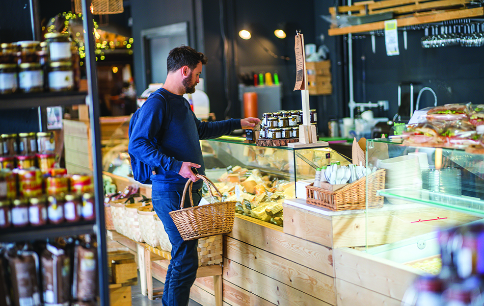 Man with basket shopping for groceries at MMy Wood Wharf